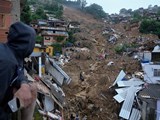 PETROPOLIS: Rescue workers and residents search for victims in a landslide-affected area of Petropolis, Brazil, on Wednesday, February 16. At least 110 people have died in Petropolis after heavy rains triggered landslides that washed out streets, swept away cars and buried homes (Silvia Izquierdo/AP)